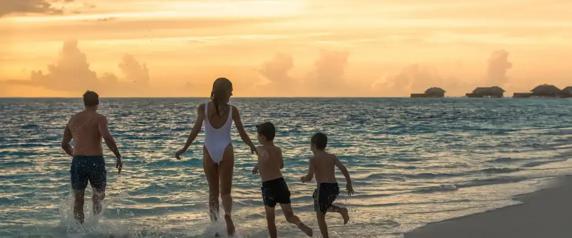 Family on the beach at sunset